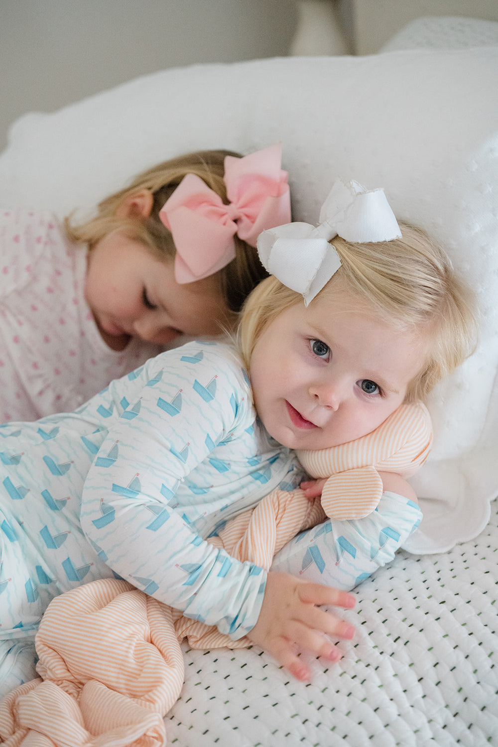 Baby outfit with blue boat pattern on a white background