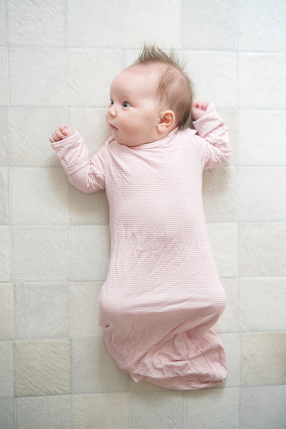 Pink baby swaddle on a white background
