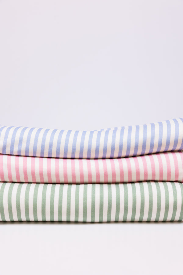 A stack of folded striped blankets in blue, pink, and green, arranged vertically with the striped patterns visible.