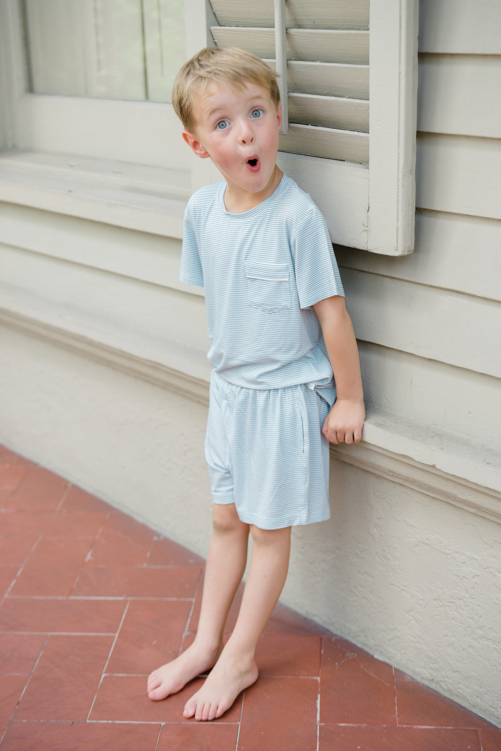 Children's striped shirt and shorts set with a tag on a white background