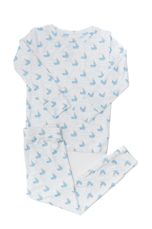 Baby outfit with blue boat pattern on a white background