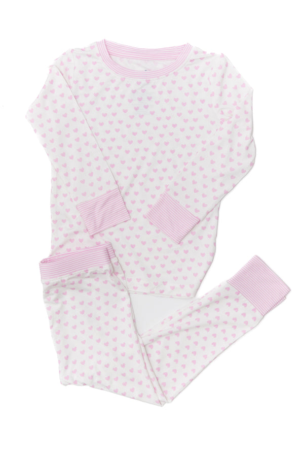 Pink and white polka dot baby outfit on a white background
