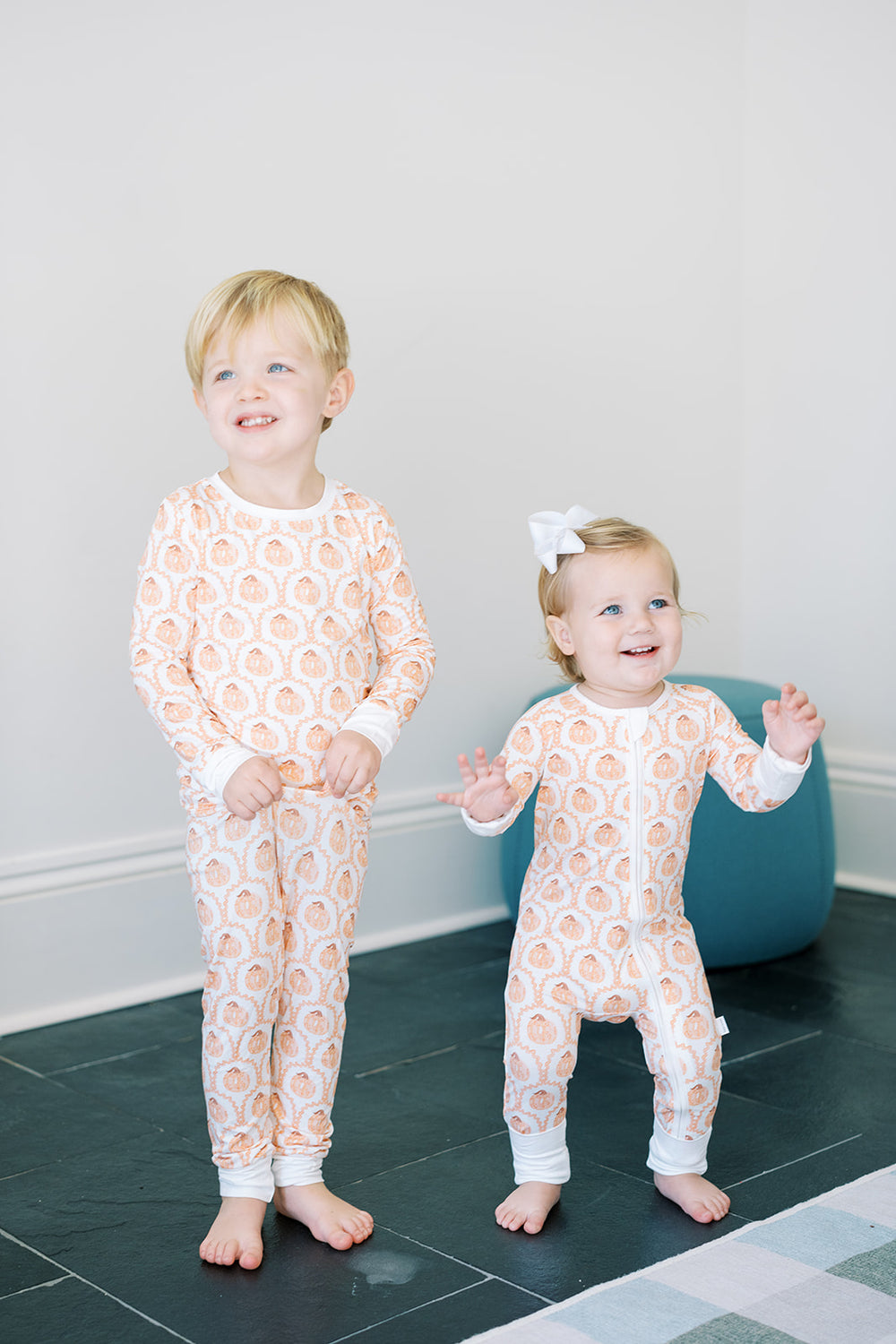 A short-sleeved baby sleep romper with a pumpkin print on a white background.