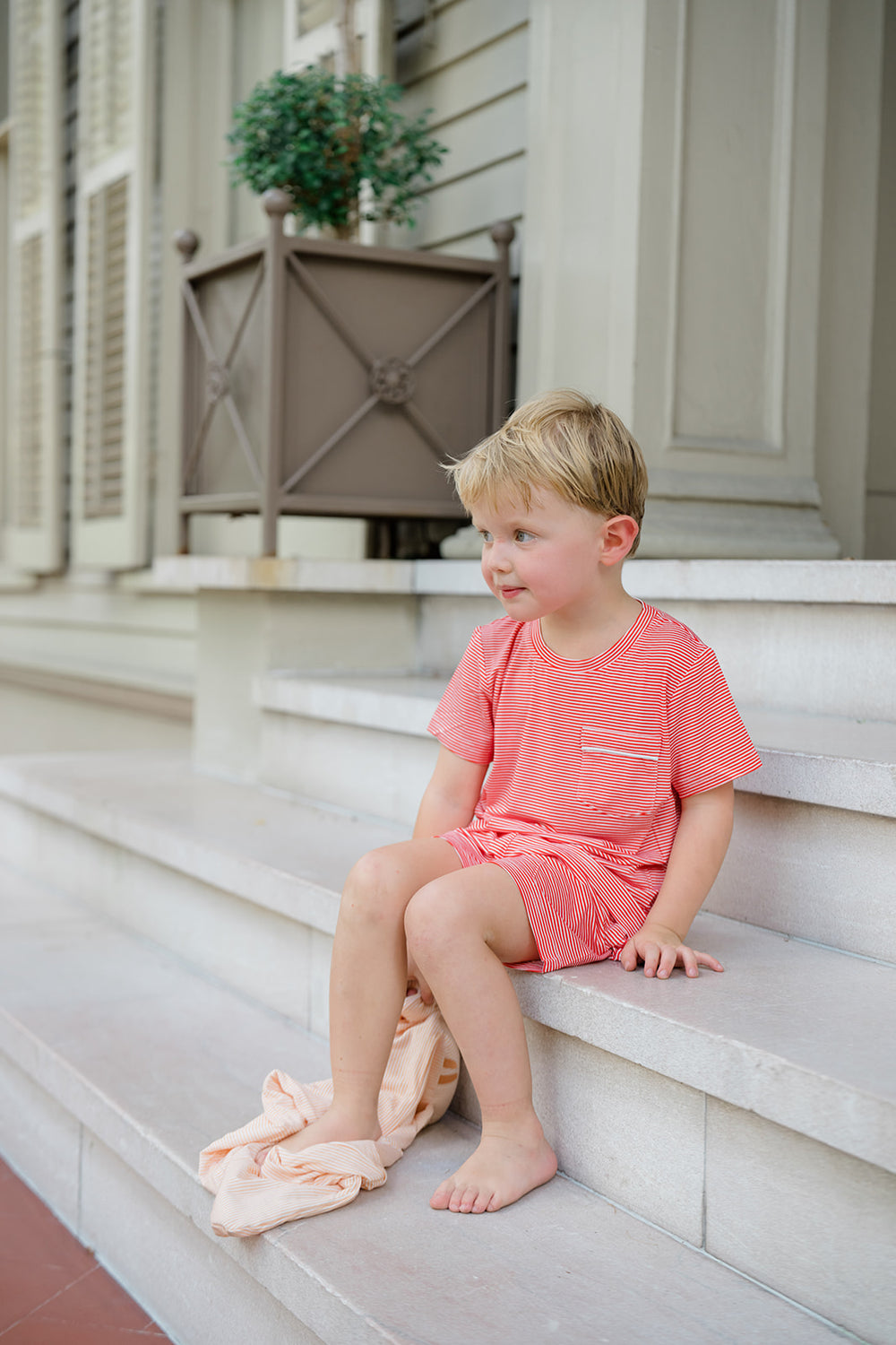 Red and white striped shirt and shorts set with a tag on a white background