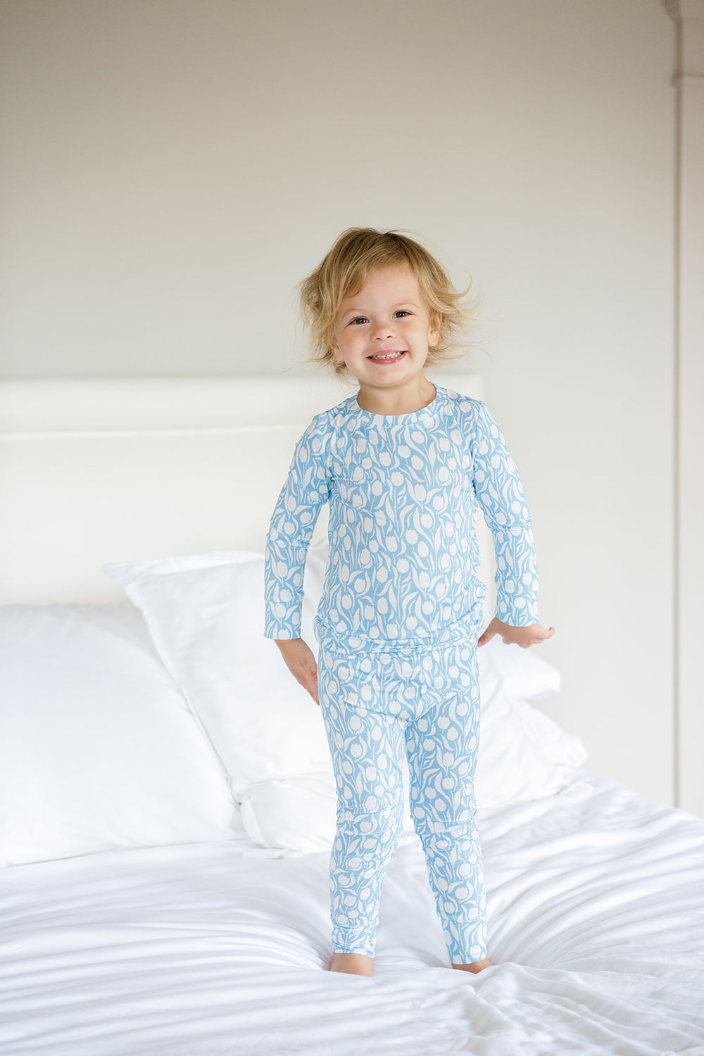 Light blue pajama set with white floral pattern on a white background
